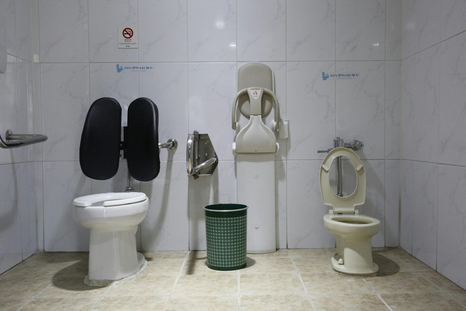 Image of a public restroom with accessible toilet facilities and a baby changing station.