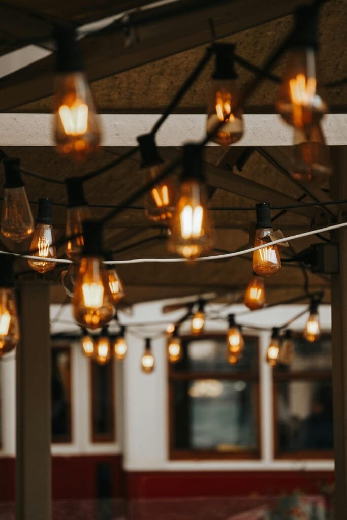 Close-up of vintage-style hanging light bulbs illuminating an outdoor space.